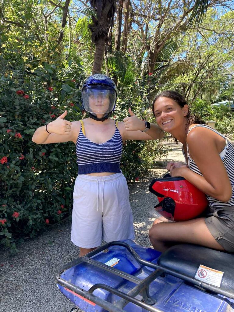 Two women sitting on an ATV in Nosara Costa Rica in the jungle
